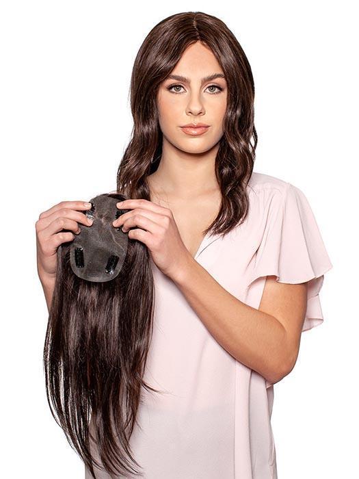 A light human hair topper that allows the hair to fall in all directions.